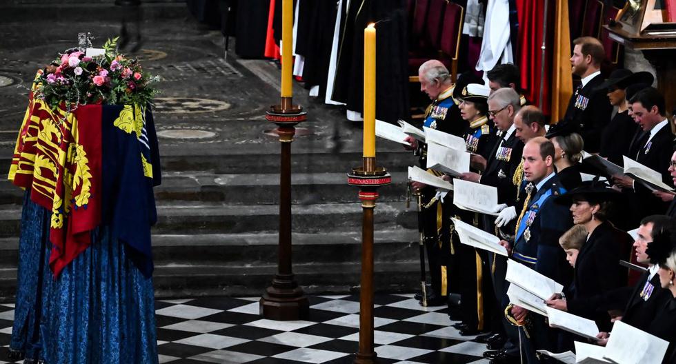 Los miembros de la familia real y los invitados cantan mientras el ataúd de la reina Isabel II, envuelto en el estandarte real, yace junto al altar durante el funeral de Estado en la Abadía de Westminster. (Ben Stansall / AFP).