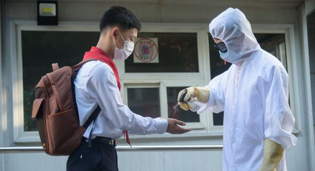 A student receives a hand sanitizer as part of anti-Covid-19 procedures before entering Pyongyang No. 1 Secondary School in Pyongyang. (Photo: KIM Won Jin / AFP).