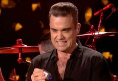 Robbie Williams es criticado por usar desinfectante luego de tocar a fans