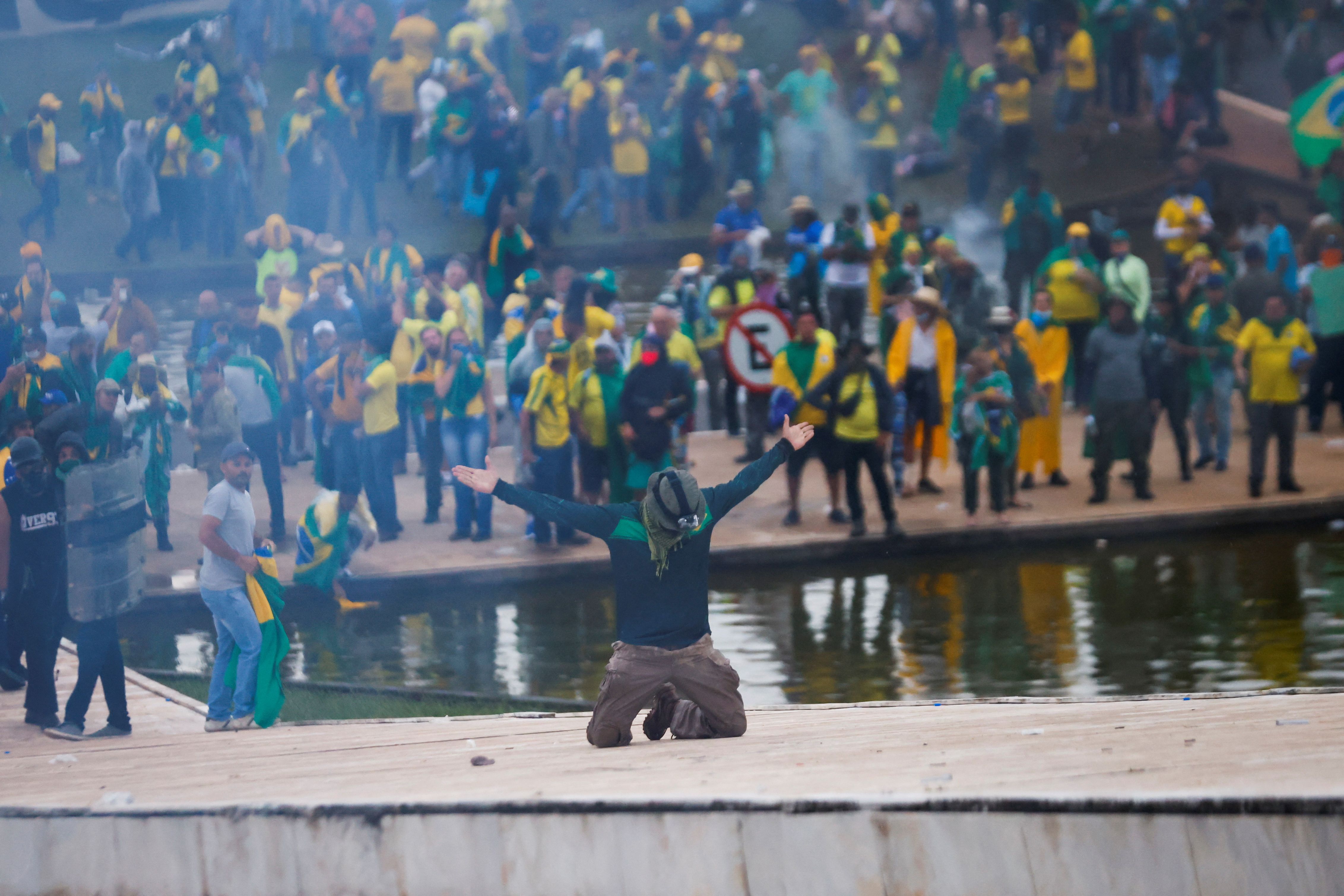 A supporter of former Brazilian President Jair Bolsonaro kneels during a demonstration against President Luiz Inácio Lula da Silva, in front of the Brazilian National Congress in Brasilia, Brazil.