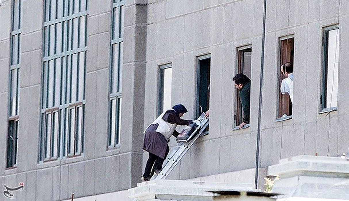 A woman is evacuated during an attack on the Iranian parliament in central Tehran, Iran, June 7, 2017. Tasnim News Agency/Handout via REUTERS ATTENTION EDITORS - THIS PICTURE WAS PROVIDED BY A THIRD PARTY. FOR EDITORIAL USE ONLY. NO RESALES. NO ARCHIVE.