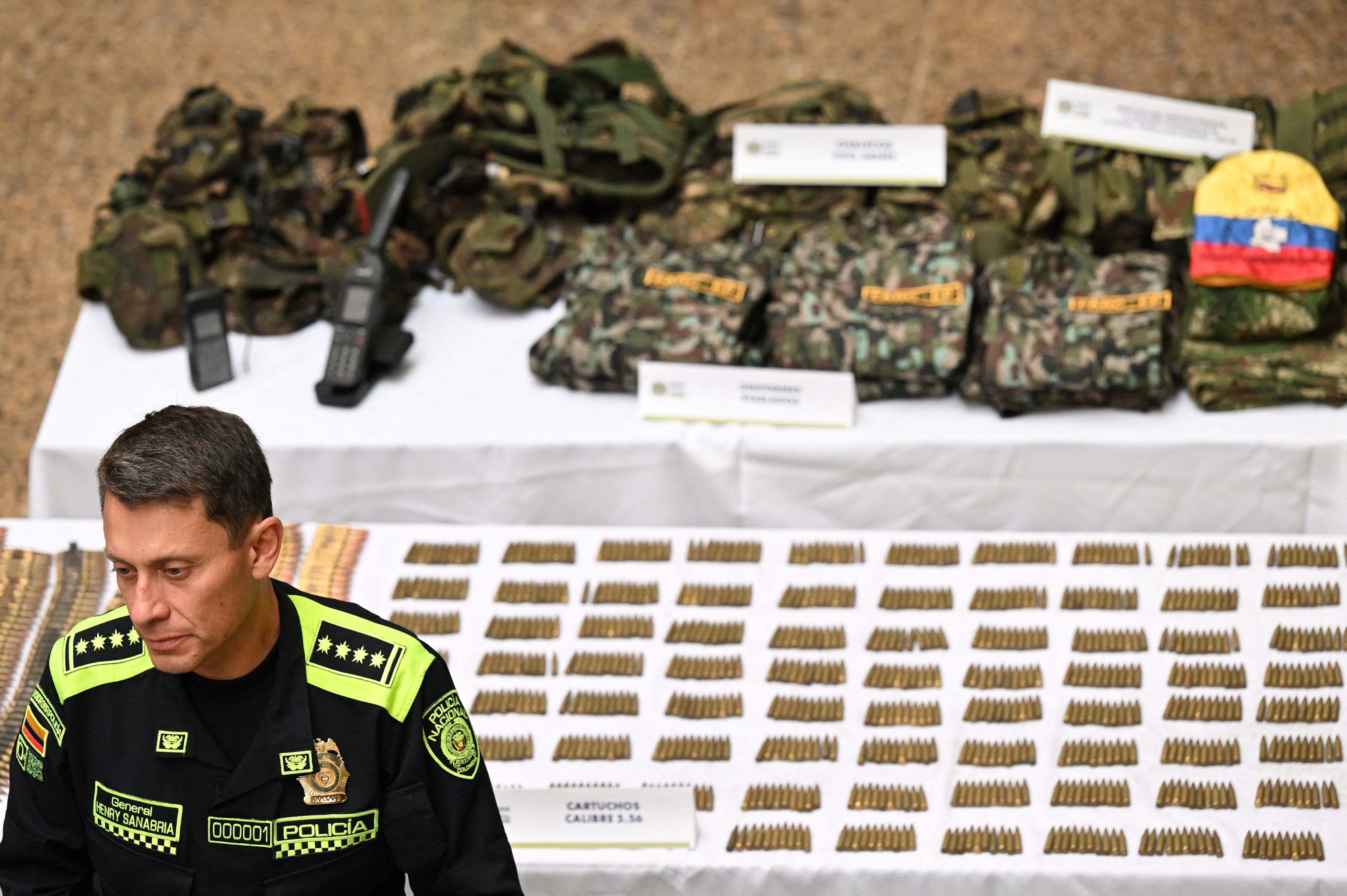 The director general of the Colombian National Police, Henry Sanabria, speaks during the presentation of a large arsenal seized from suspected dissidents of the Revolutionary Armed Forces of Colombia.  (Photo by Raúl ARBOLEDA / AFP).