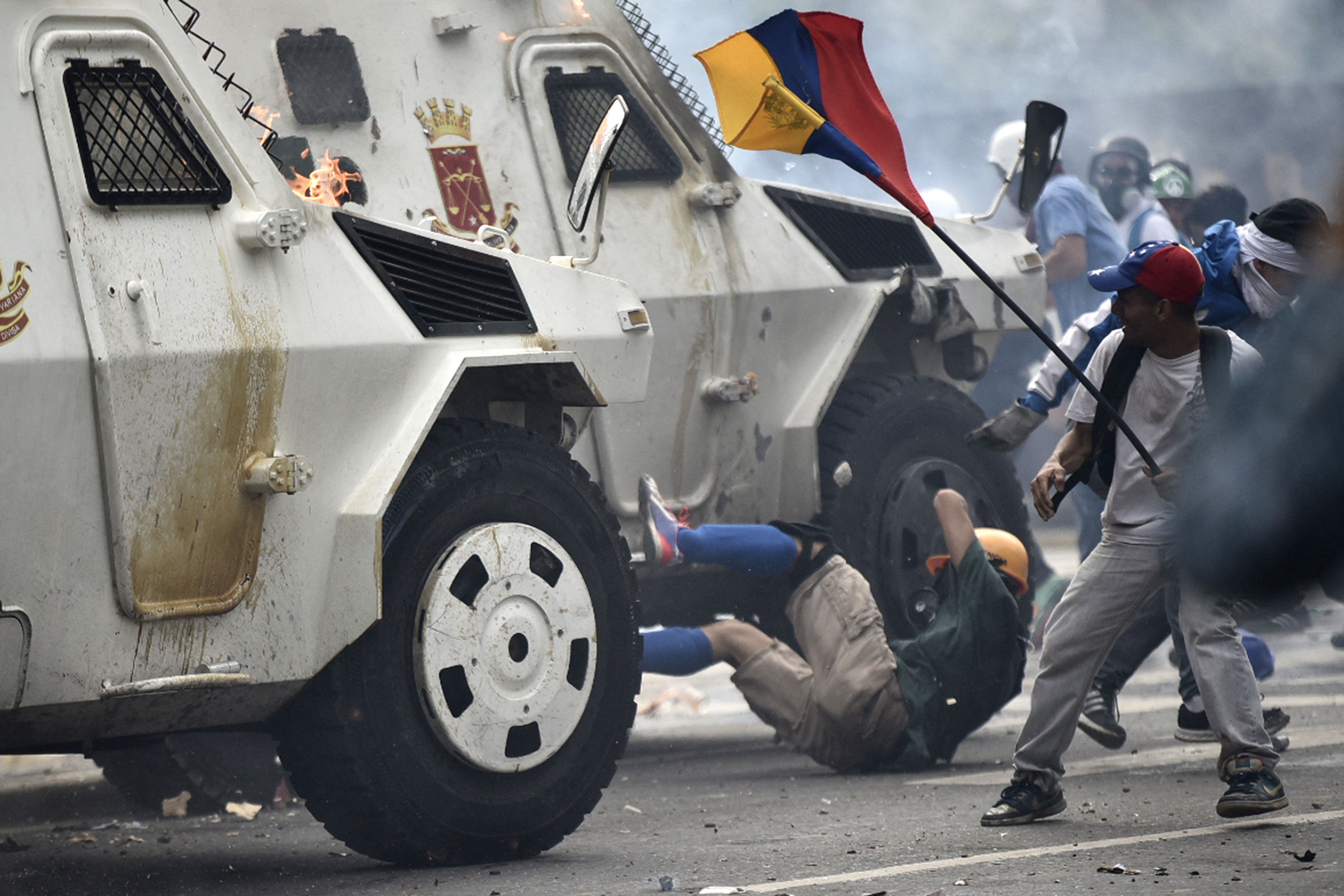 A Bolivarian National Guard riot vehicle knocks down a protester during a protest against Venezuelan President Nicolás Maduro, on May 3, 2017. (Photo by Carlos BECERRA/AFP).