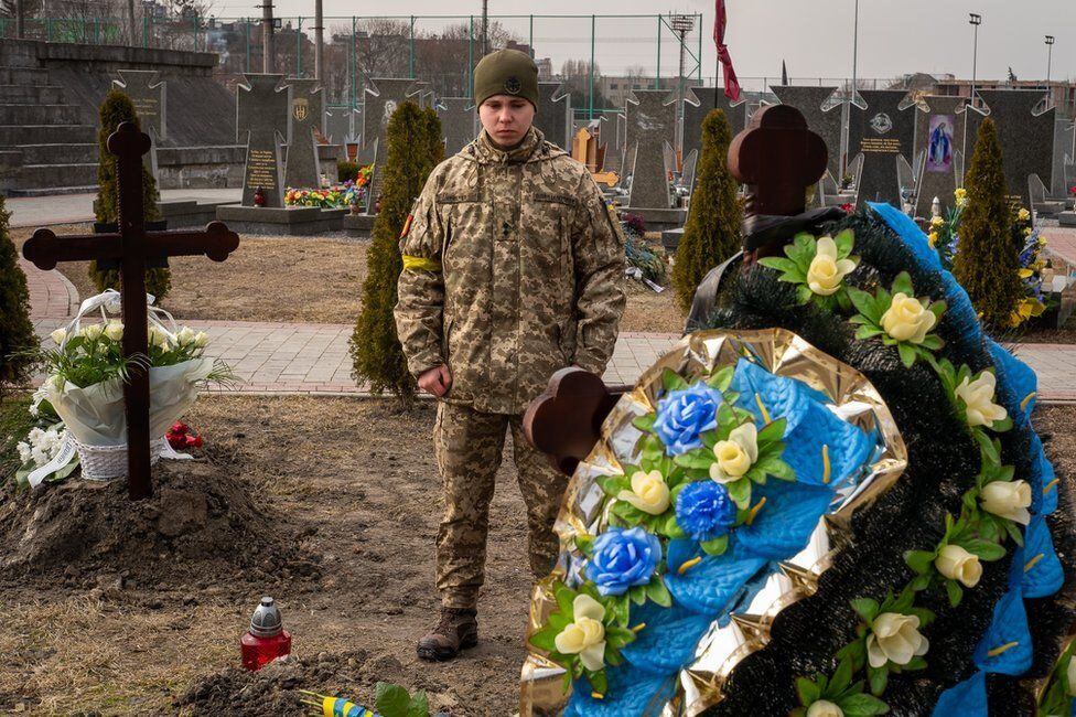 Vadym Yarovenko traveled alone to see his friend buried.  He is waiting for his turn to be called to the front.