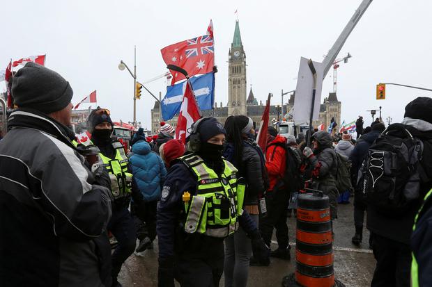 Police officers walk through the protesting crowd in front of Parliament Hill, as truckers and supporters continue to protest coronavirus disease (COVID-19) vaccination mandates, in Ottawa, Ontario, Canada.  (Photo: REUTERS/Lars Hagberg).
