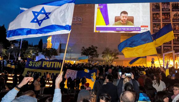 Los manifestantes se reúnen en la ciudad costera mediterránea de Tel Aviv, Israel, el 20 de marzo de 2022 para escuchar un discurso del presidente de Ucrania, Volodymyr Zelensky. (JACK GUEZ / AFP).