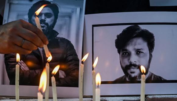 Periodistas colocan velas junto al retrato del periodista de Reuters, el danés Siddiqui, como tributo en Calcuta. (Foto: DIBYANGSHU SARKAR / AFP)