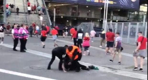 Stadium security tries to slow down fans rushing into the Stade de France to watch the Champions League final.