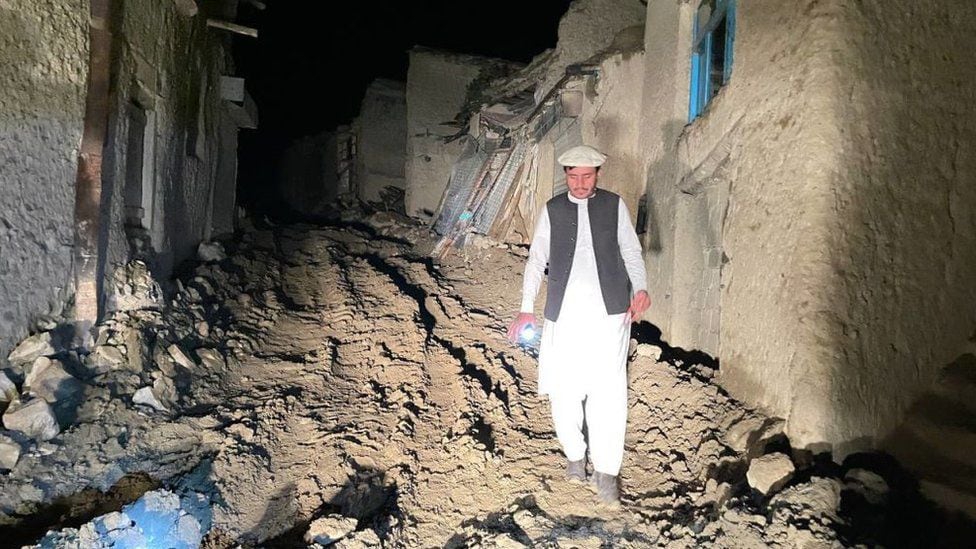 A man walks in the dark in the earthquake zone in Afghanistan.