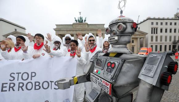 Las personas participan en una manifestación como parte de la campaña "Stop Killer Robots" organizada por la ONG alemana "Facing Finance" para prohibir lo que llaman robots asesinos el 21 de marzo de 2019 frente a la Puerta de Brandenburgo en Berlín. (Foto de Wolfgang Kumm /dpa/AFP)