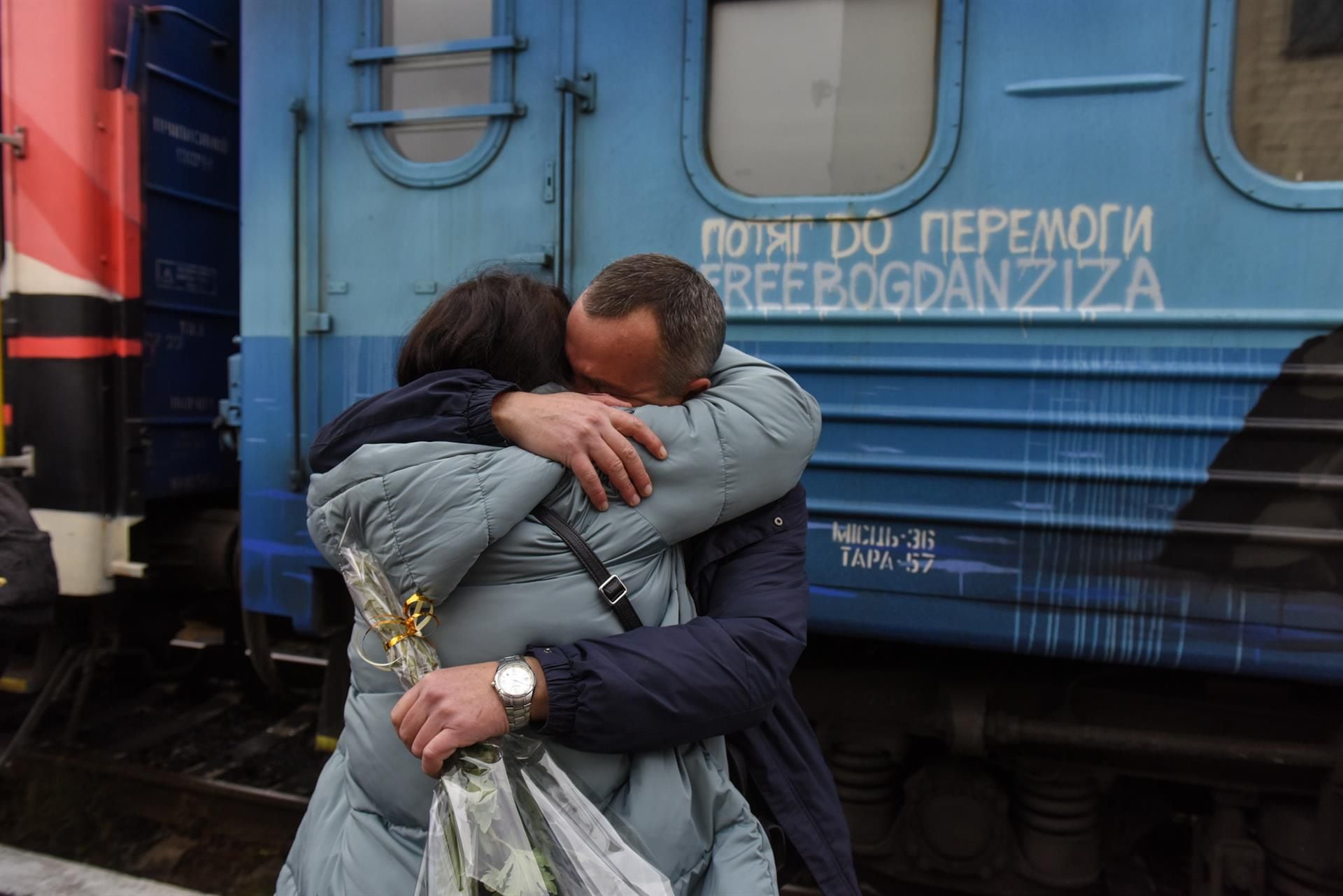 Andriy hugs his wife Olga as they meet again after three months at the Kherson train station, in southern Ukraine, on November 19, 2022. (EFE/EPA/OLEG PETRASYUK).