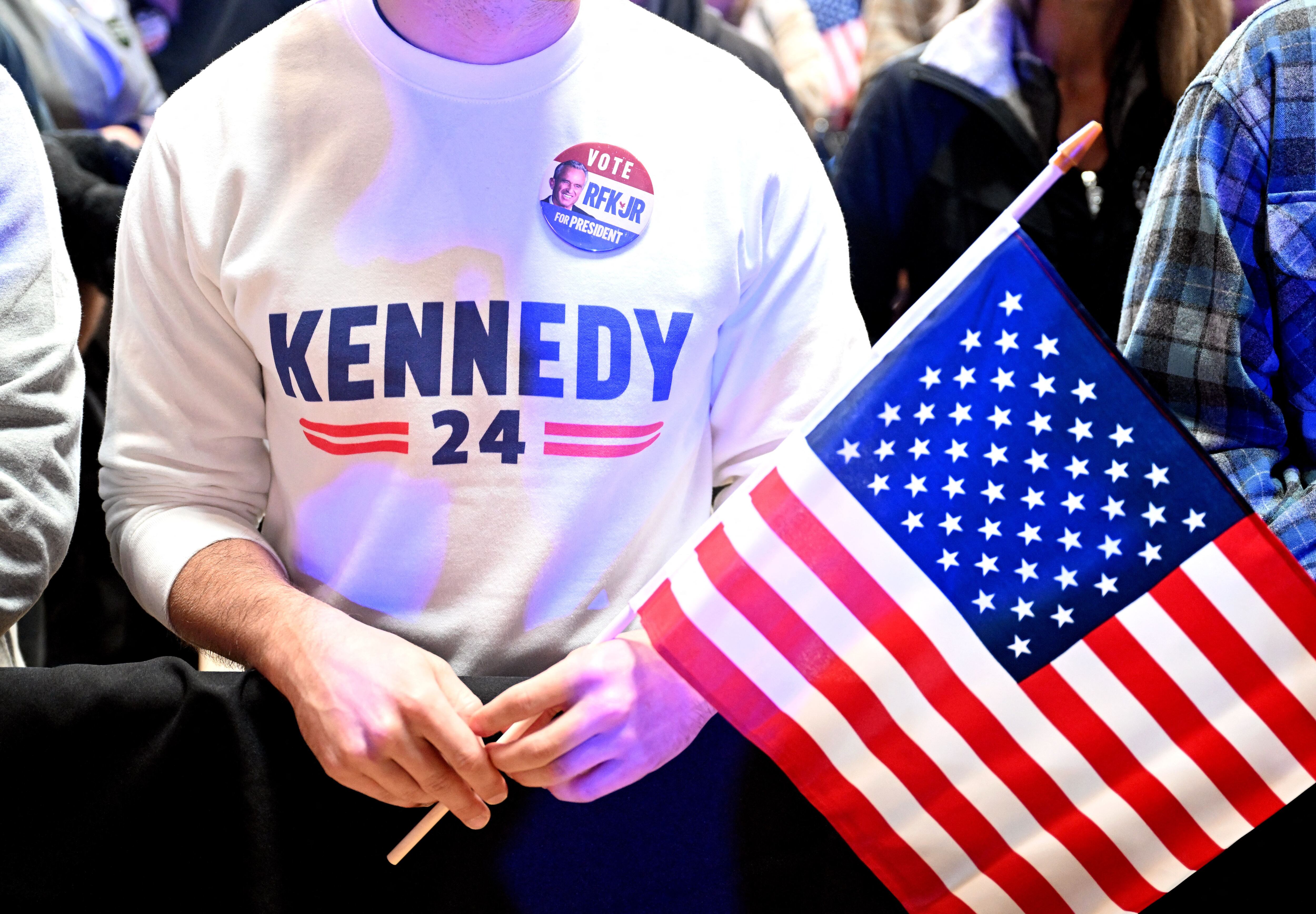 A supporter holds an American flag during a Robert F. Kennedy Jr. campaign event (Photo by JOSH EDELSON/AFP).