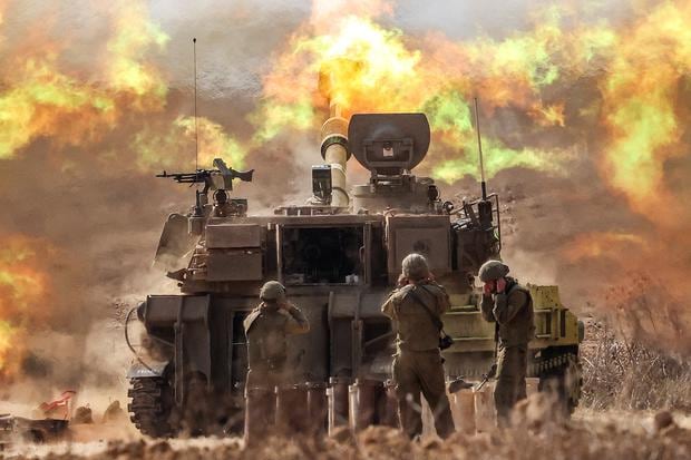 An Israeli Army M109 155mm self-propelled howitzer fires near the border with southern Israel in Gaza on October 11, 2023.  (Photo by JACK GUEZ / AFP).