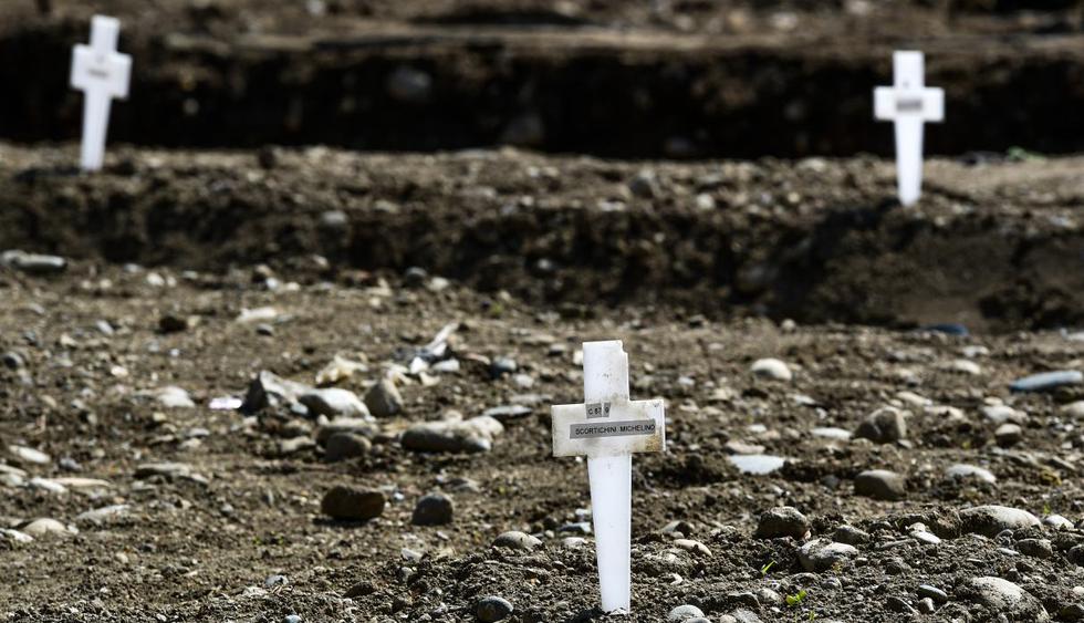 Tres cruces en el área llamada Campo 87, donde unos 60 cuerpos no reclamados de personas que murieron por coronavirus, han sido enterrados por el municipio en el cementerio Maggiore en Milán. (Miguel MEDINA / AFP).