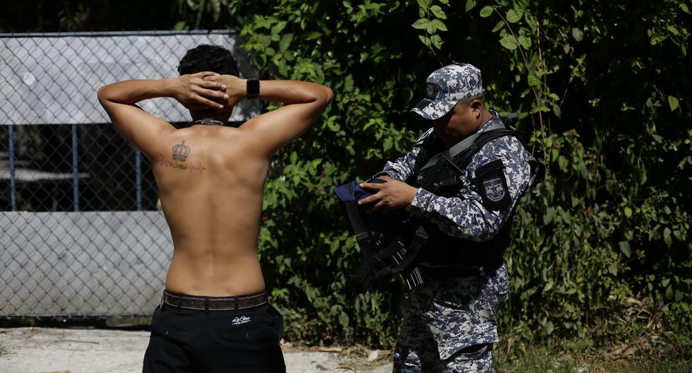 Un policía salvadoreño realiza hoy una requisa en Soyapango (El Salvador). Unos 10.000 miembros de la Fuerza Armada y de la Policía Nacional Civil (PNC) fueron desplegados en el municipio populoso de Soyapango para "extraer" a pandilleros que aún no han sido capturados y continuar la "guerra contra las pandillas". EFE/ Rodrigo Sura