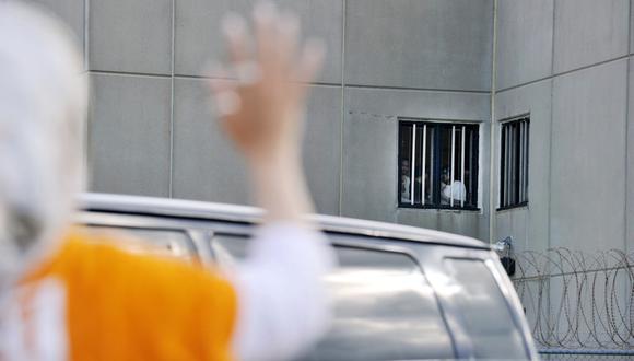 Imagen referencial. Una mujer saluda a los detenidos en el Centro de Detención del Condado de Strafford en Estados Unidos. (Foto: AFP)