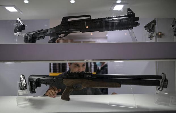 Importer Diego Villalba shows his non-lethal weapons in Bogotá, on September 17, 2021. (Juan BARRETO / AFP).