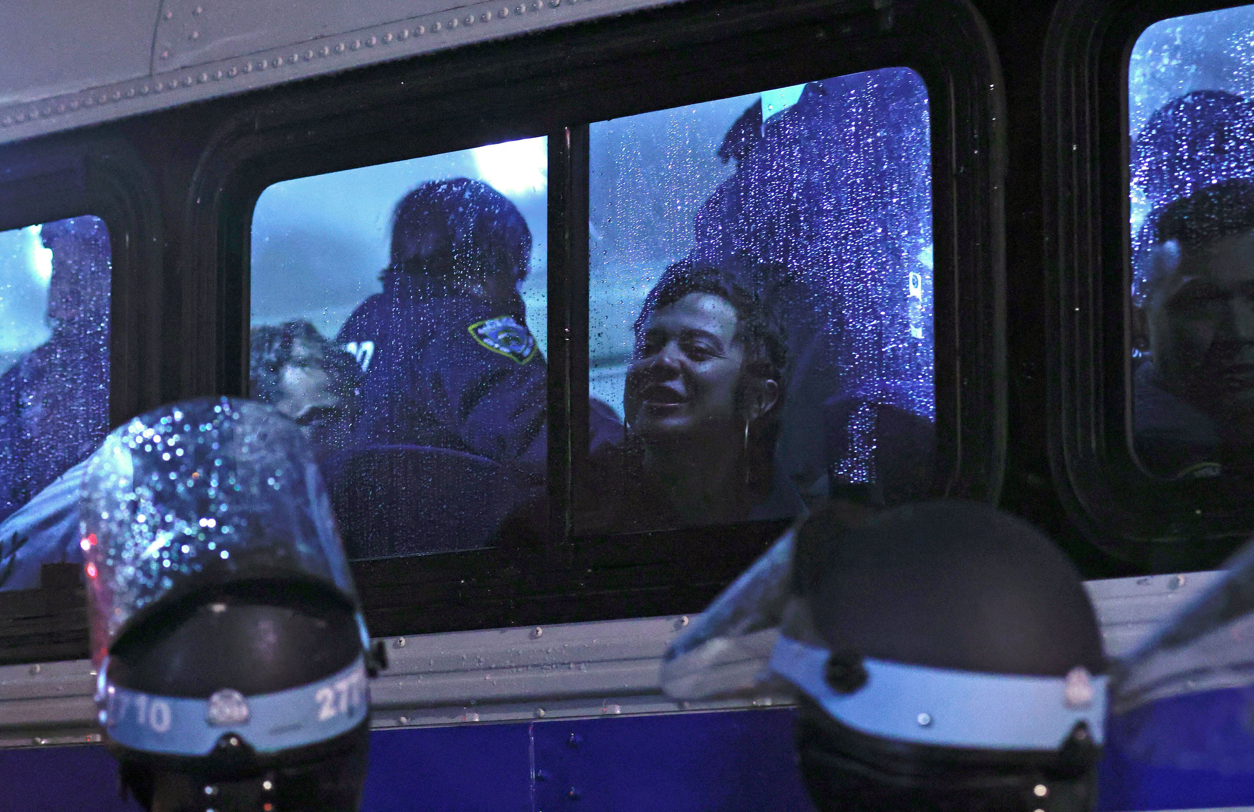 NYPD officers transport stranded students on a bus as they clean a building they occupied at Columbia University, April 30, 2024. (Photo by Kena BETANCUR/AFP).