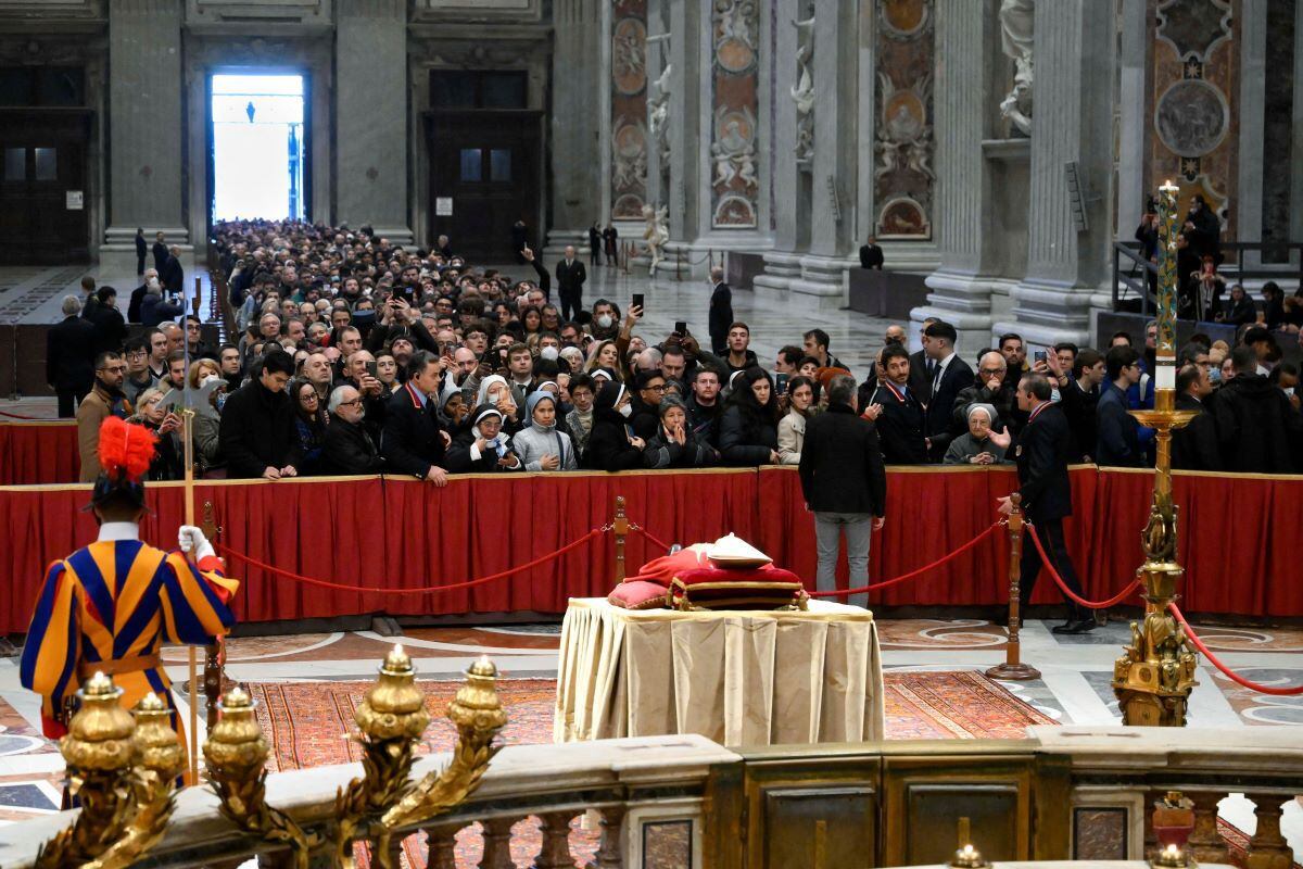This photo taken on January 2, 2023 by Vatican media shows people waiting in line to pay their respects before the body of emeritus Pope Benedict XVI in St. Peter's Basilica.  (AFP).