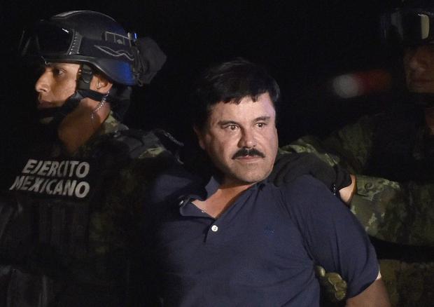 Drug lord Joaquín El Chapo Guzmán is escorted to a helicopter at the Mexico City airport on January 8, 2016 after his recapture.