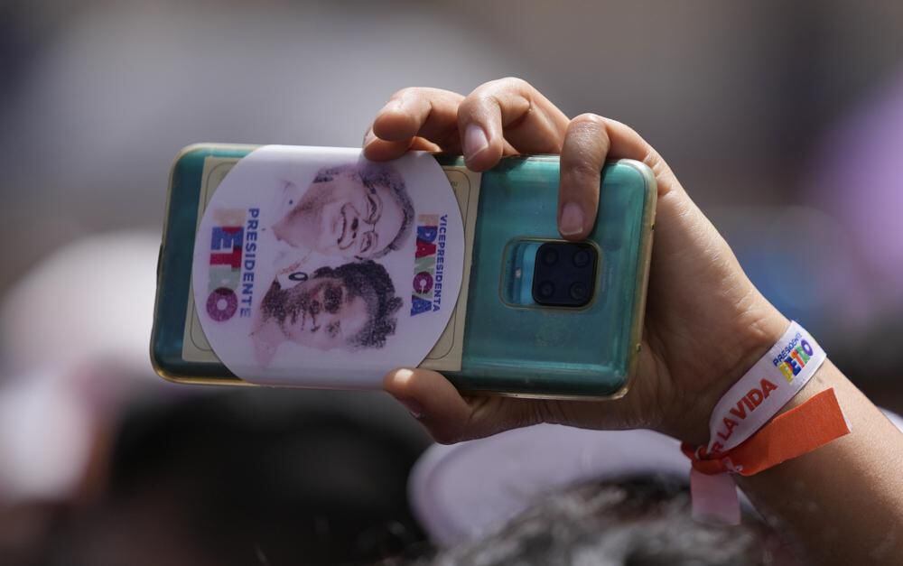 A supporter of the presidential candidate of the Historical Pact coalition, Gustavo Petro, records him during a campaign closing rally in Zipaquirá, Sunday, May 22, 2022. (AP Photo/Fernando Vergara).