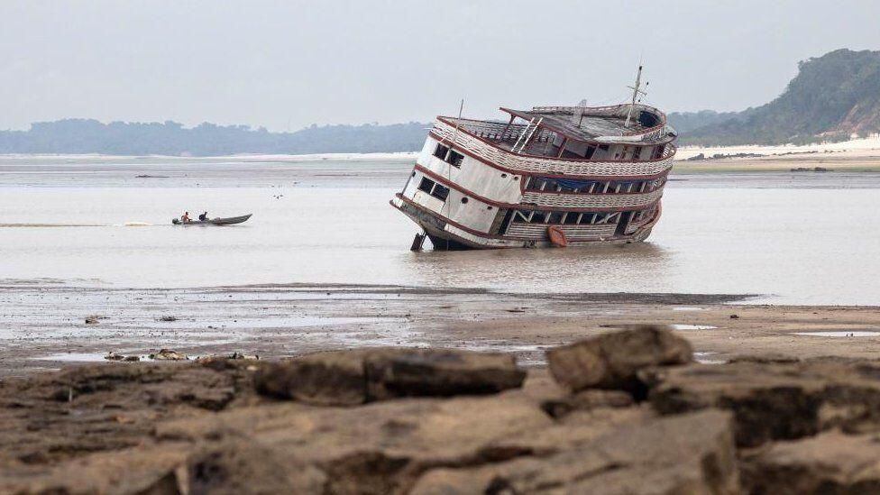 The level of the Rio Negro is so low that it leaves boats stranded on the sandbanks.  (EPA).
