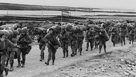 Soldados argentinos son vistos el 13 de abril de 1982 en su camino para ocupar la base de los Royal Marines capturada en Puerto Argentino / Port Stanley, pocos días después de que la dictadura militar argentina tomara las islas Malvinas. (FOTO AFP Daniel GARCIA).