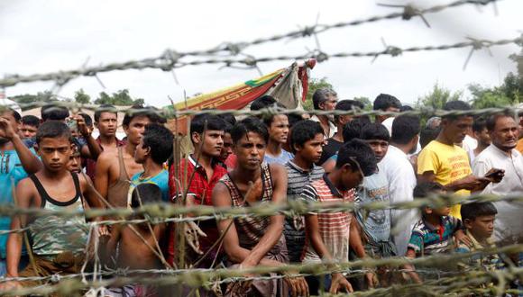 Un grupo de refugiados rohinyá tras una valla en "tierra de nadie" entre la frontera de Bangladesh y Birmania en el distrito de Maungdaw, estado Rakhine, oeste de Birmania. (Foto: EFE)