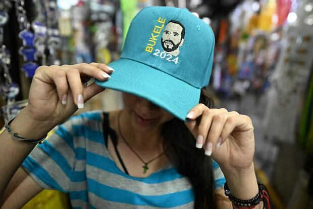 A hat with the face of the president of El Salvador, Nayib Bukele, is sold at the Ex Cuartel market in San Salvador, on January 30, 2024. (Photo by Marvin RECINOS / AFP)