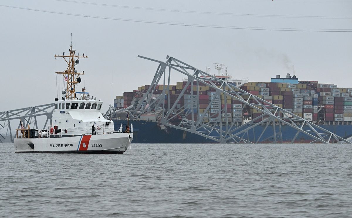 A U.S. Coast Guard Cutter Mako patrols near the collapsed Francis Scott Key Bridge after it was struck by the Dali container ship in Baltimore, Maryland, March 27, 2024. (Photo by Jim WATSON/AFP)
