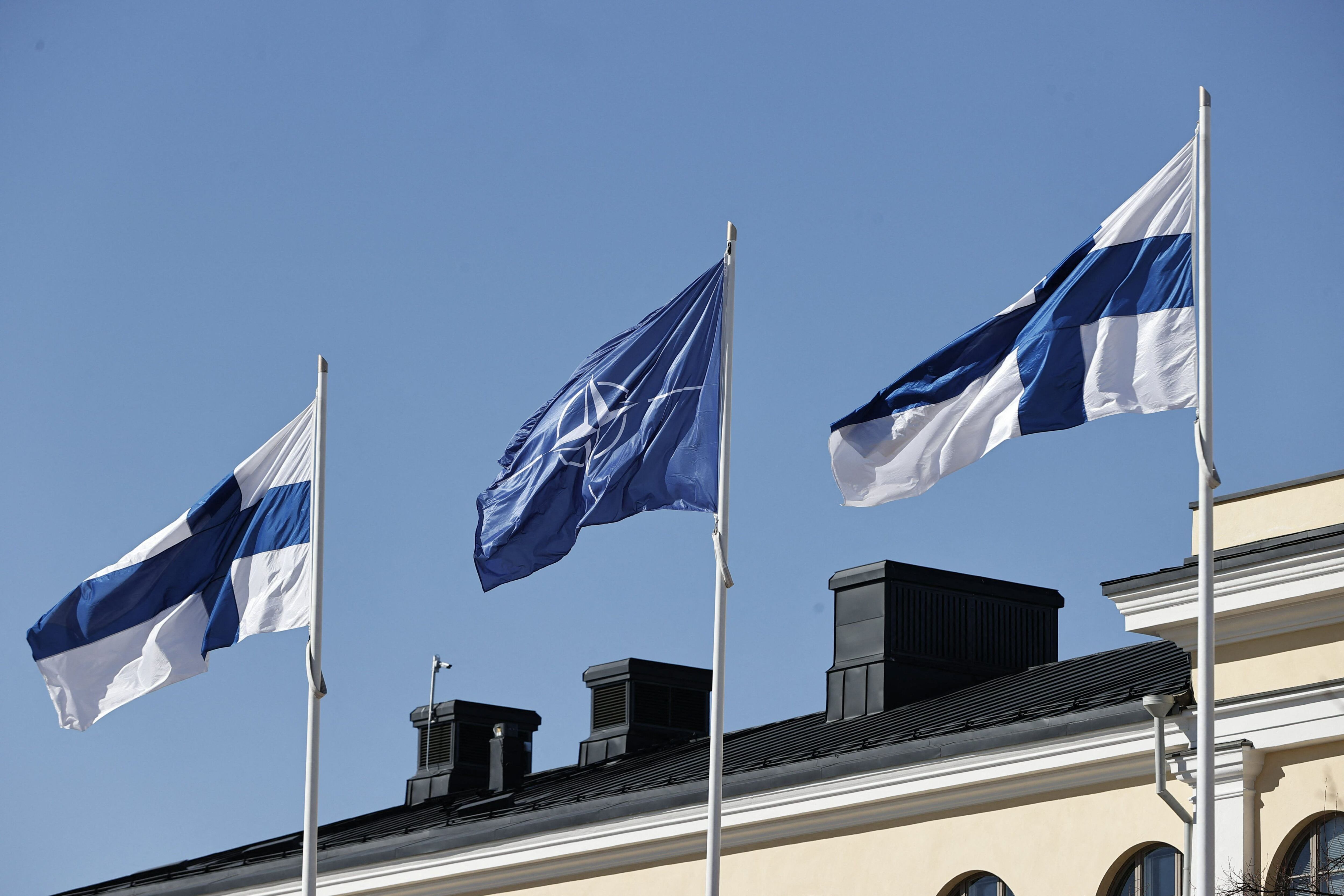 The flags of Finland and NATO fly in the courtyard of the Finnish Ministry of Foreign Affairs, April 4, 2023. (Photo by Antti Hml inen/Lehtikuva/AFP).