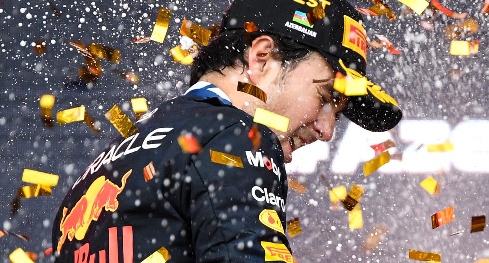 Red Bull Racing's Mexican driver Sergio Perez celebrates on the podium after winning the Formula One Azerbaijan Grand Prix at the Baku City Circuit in Baku on April 30, 2023. (Photo by NATALIA KOLESNIKOVA / AFP)