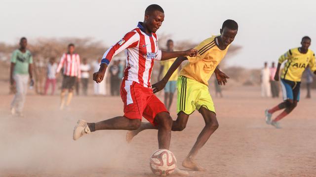 Personal de Médicos Sin Fronteras (MSF) y refugiados del campo de Dagahaley juegan al fútbol en Dadaab, en Kenia. MSF trabaja en Dadaab hace más de 20 años. (Tom Maruko)