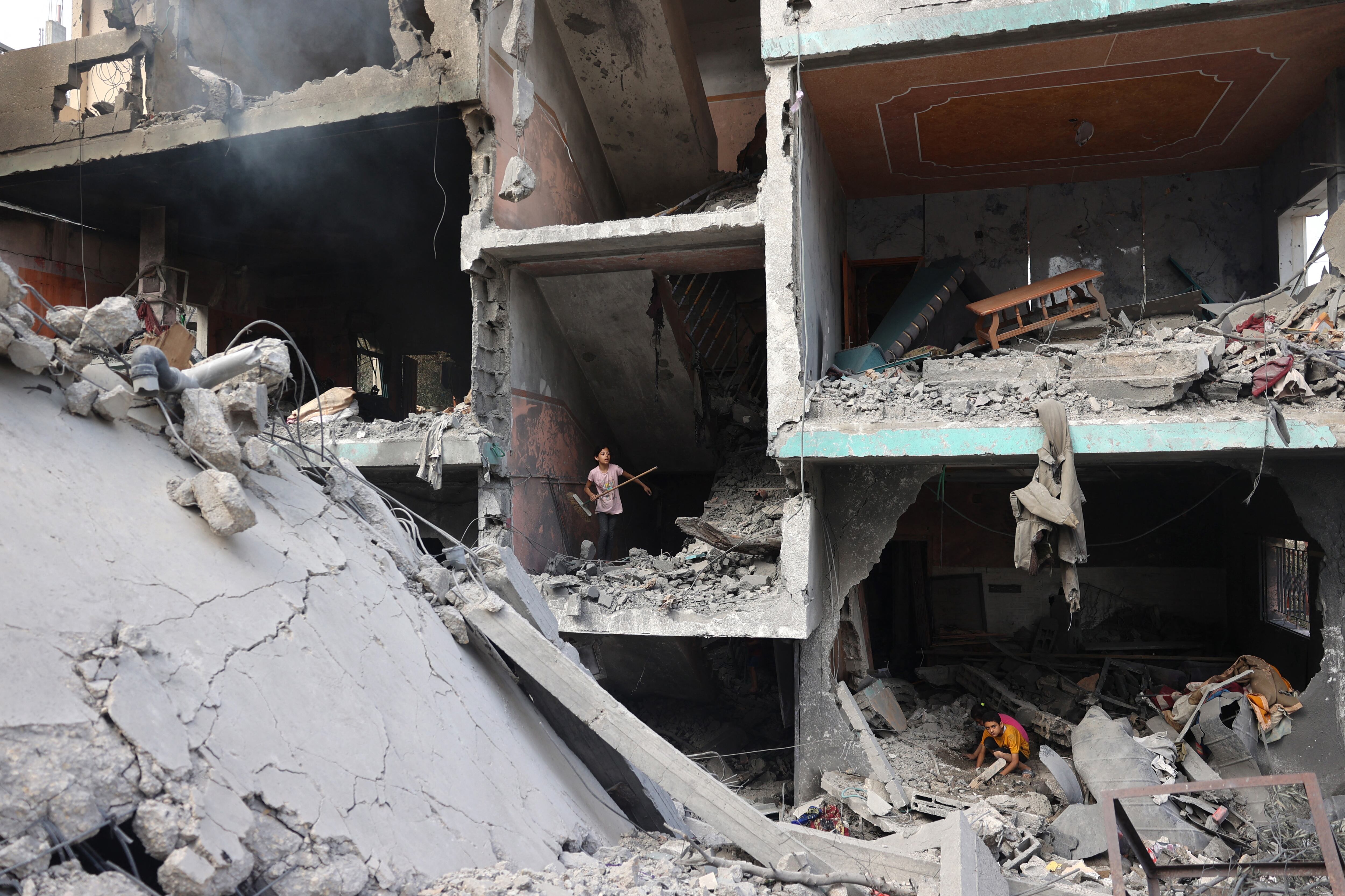 Palestinian children walk through the rubble of their home a day after an Israeli Special Forces operation in the Nuseirat camp.  (Photo: AFP)