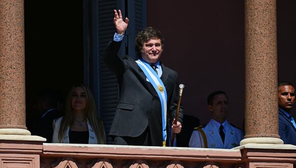 El nuevo presidente de Argentina, Javier Milei, saluda a la multitud desde un balcón del palacio de gobierno de la Casa Rosada durante el día de su toma de posesión en Buenos Aires el 10 de diciembre de 2023. (Foto de Pablo PORCÍUNCULA/AFP)