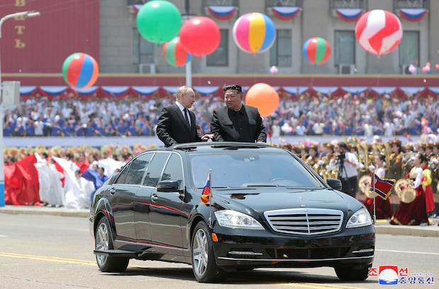 This photo is taken of Kim and Putin in an open car during a welcome ceremony at Kim Il-sung Square in Pyongyang on June 19, 2024.  (AFP).