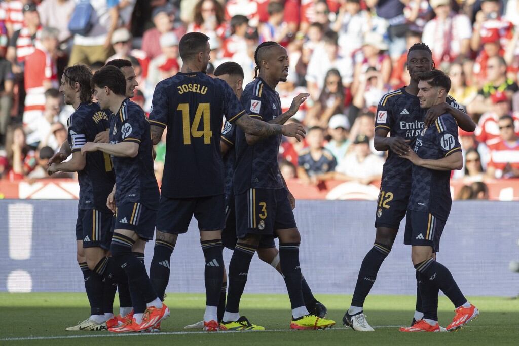 Real Madrid's Spanish forward #21 Brahim Diaz (R) celebrates with teammates after scoring during the Spanish League football match between Granada FC and Real Madrid CF at Nuevo Los Carmenes stadium in Granada on May 11, 2024. (Photo by JORGE GUERRERO / AFP)