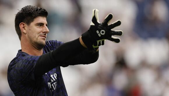 Real Madrid's Belgian goalkeeper Thibaut Courtois puts his gloves on before the Spanish league football match between Real Madrid CF and Cadiz CF at the Santiago Bernabeu stadium in Madrid on May 4, 2024. (Photo by OSCAR DEL POZO / AFP)