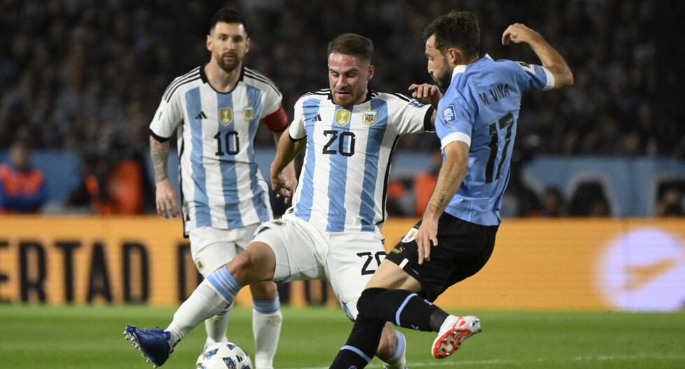 Argentina's midfielder Alexis Mac Allister (C) and Uruguay's defender Matias Vina (R) fight for the ball during the 2026 FIFA World Cup South American qualification football match between Argentina and Uruguay at La Bombonera stadium in Buenos Aires on November 16, 2023. (Photo by Luis ROBAYO / AFP)