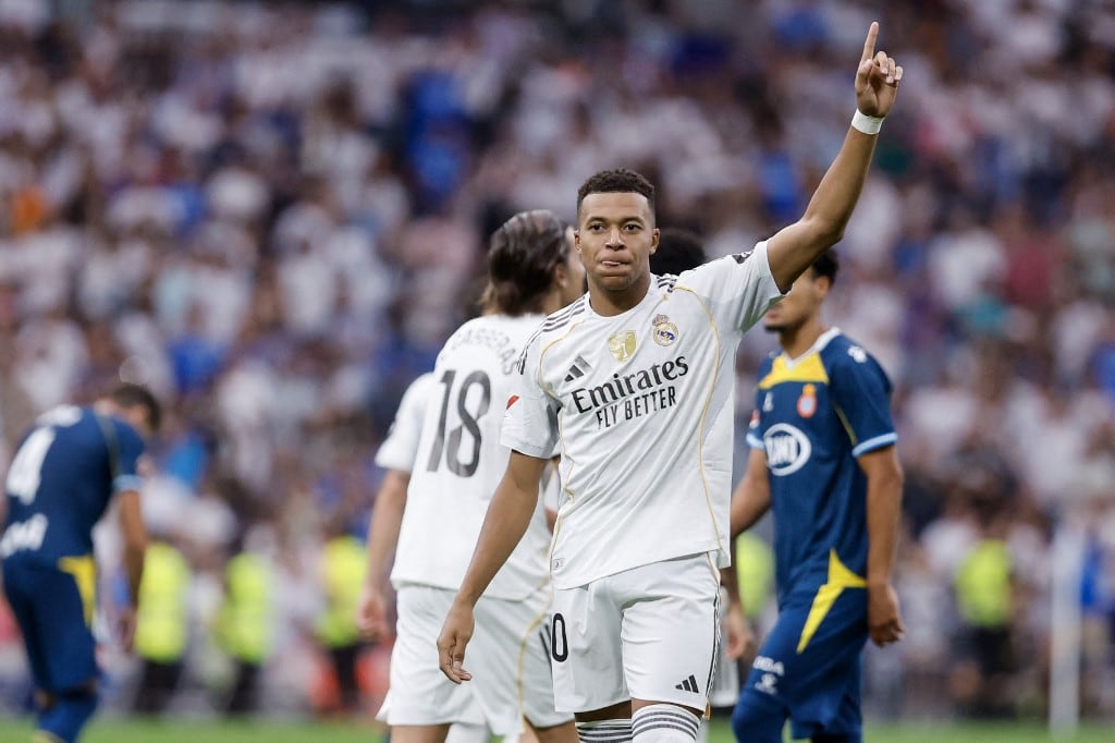 Real Madrid's French forward #10 Kylian Mbappe celebrates after scoring their second goal during the Spanish league football match between Real Madrid CF and RCD Espanyol at the Santiago Bernabeu stadium in Madrid on September 20, 2025. (Photo by Oscar DEL POZO / AFP)