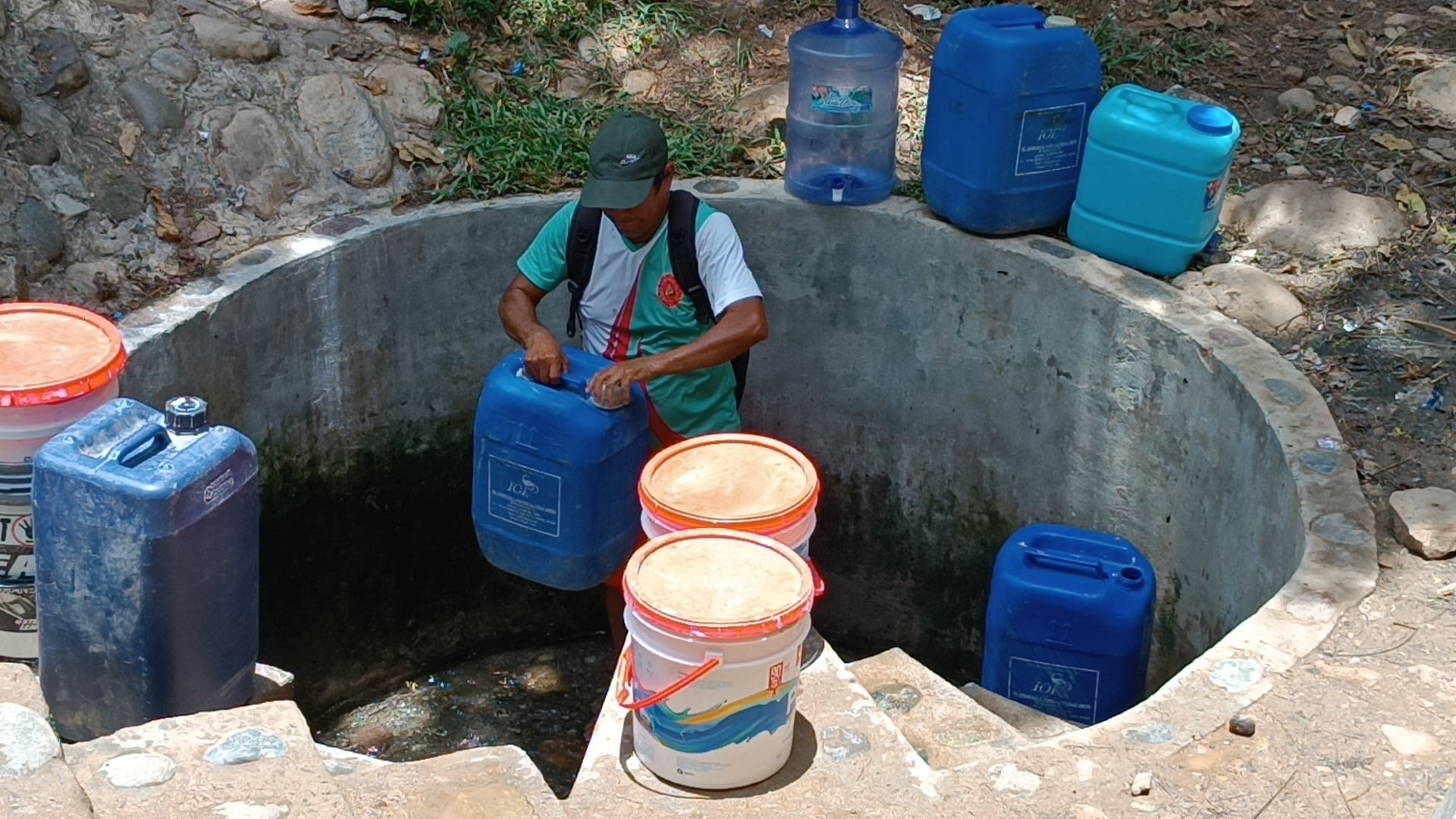 Alcides Sánchez recogiendo agua de una manantial. Foto: Hugo Anteparra