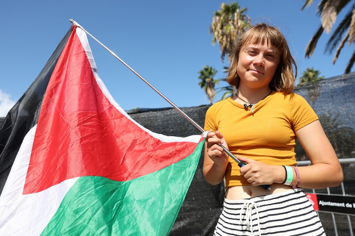 La activista climática sueca Greta Thunberg posa con una bandera palestina mientras una flotilla que transporta ayuda humanitaria y activistas se preparan para partir hacia Gaza, en Barcelona, el 30 de agosto de 2025. (Foto de LLUIS GENE / AFP)
