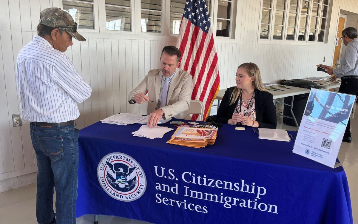 unos funcionarios de USCIS orientando a una persona. (Foto: USCIS)