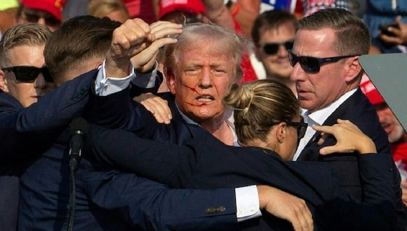El candidato republicano Donald Trump con sangre en el rostro rodeado de agentes del servicio secreto en un evento de campaña en Butler Farm Show Inc. en Butler, Pensilvania, el 13 de julio de 2024. (Foto de Rebecca DROKE / AFP)