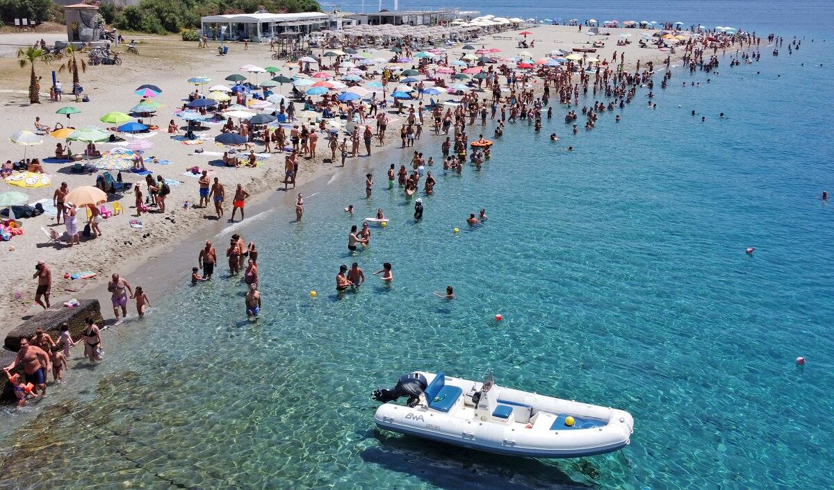 La playa de Torre Faro Pilone cerca de Messina en la isla de Sicilia, llena de bañistas durante una ola de calor el 16 de julio de 2023. (Foto de GIOVANNI ISOLINO / AFP)