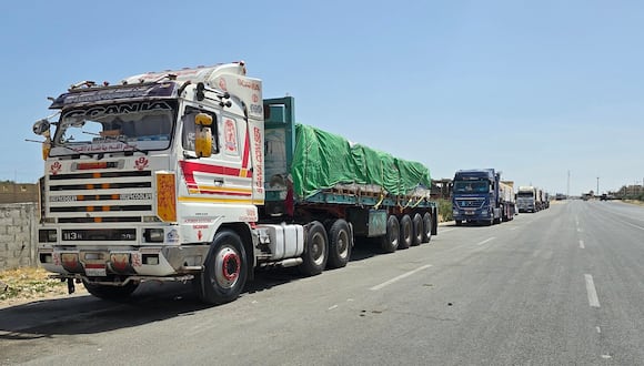 Camiones egipcios que transportan ayuda humanitaria con destino a la Franja de Gaza esperan cerca del cruce fronterizo de Rafah en el lado egipcio, el 26 de mayo de 2024. (Foto de AFP)