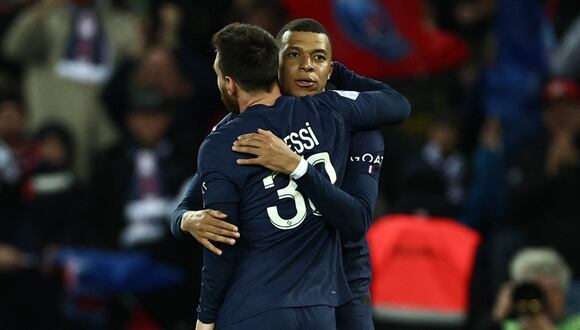 Paris Saint-Germain's Argentine forward Lionel Messi is congratulated by Paris Saint-Germain's French forward Kylian Mbappe after scoring his team's third goal during the French L1 football match between Paris Saint-Germain (PSG) and Lens (RCL) at the Parc des Princes in Paris, on April 15, 2023. (Photo by Anne-Christine POUJOULAT / AFP)