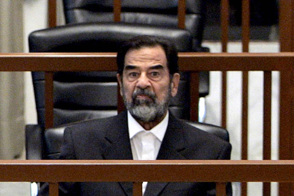 El derrocado presidente de Irak, Saddam Hussein, asiste a su juicio celebrado en Bagdad, el 22 de mayo de 2006. (MARCO DI LAURO / POOL / AFP)