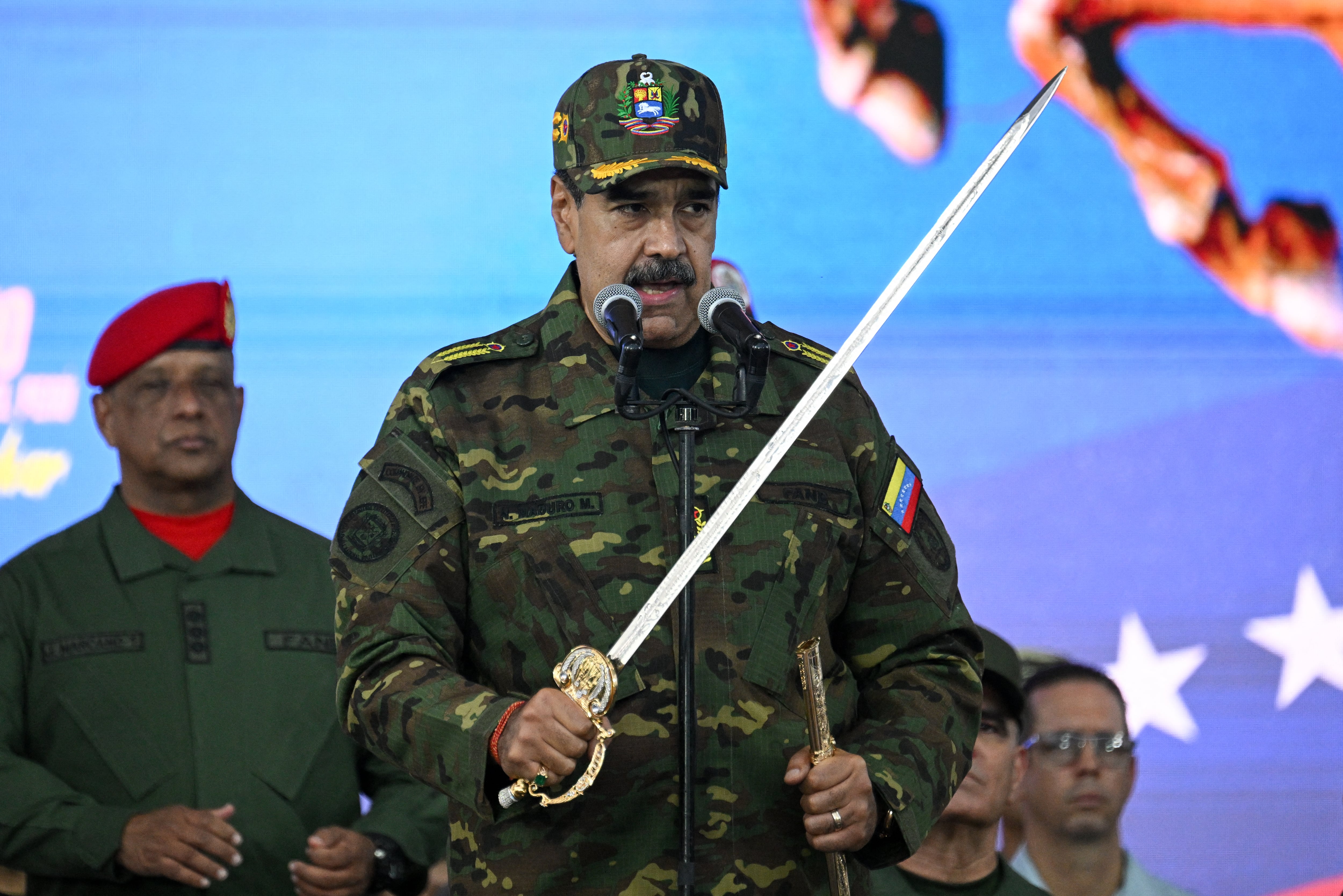 Nicolás Maduro pronuncia un discurso mientras sostiene la "Espada del Perú" del héroe independentista venezolano Simón Bolívar durante una ceremonia militar en Fuerte Tiuna, Caracas, el 25 de noviembre de 2025. (Foto: Federico PARRA / AFP).