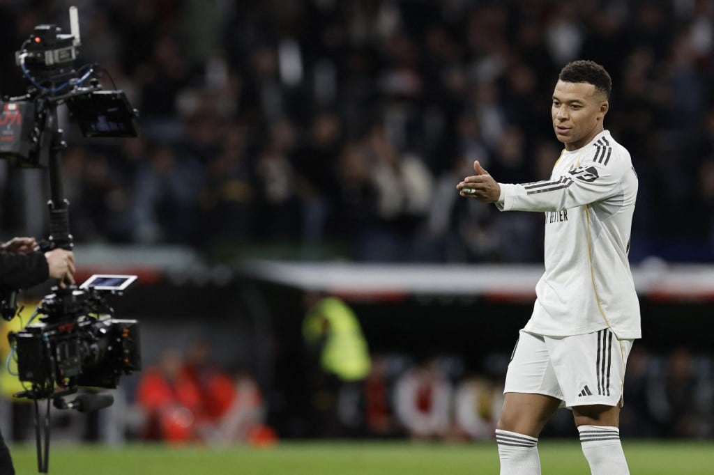 Real Madrid's French forward #10 Kylian Mbappe celebrates scoring his team's second goal during the Spanish league football match between Real Madrid CF and Sevilla FC at Santiago Bernabeu Stadium in Madrid on December 20, 2025. (Photo by Oscar DEL POZO / AFP)